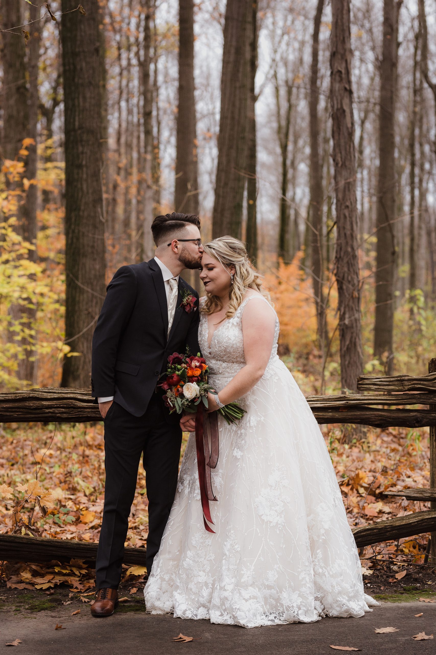 Wedding photo bride and groom portraits hair dress bouquet fall autumn colours leaves trees