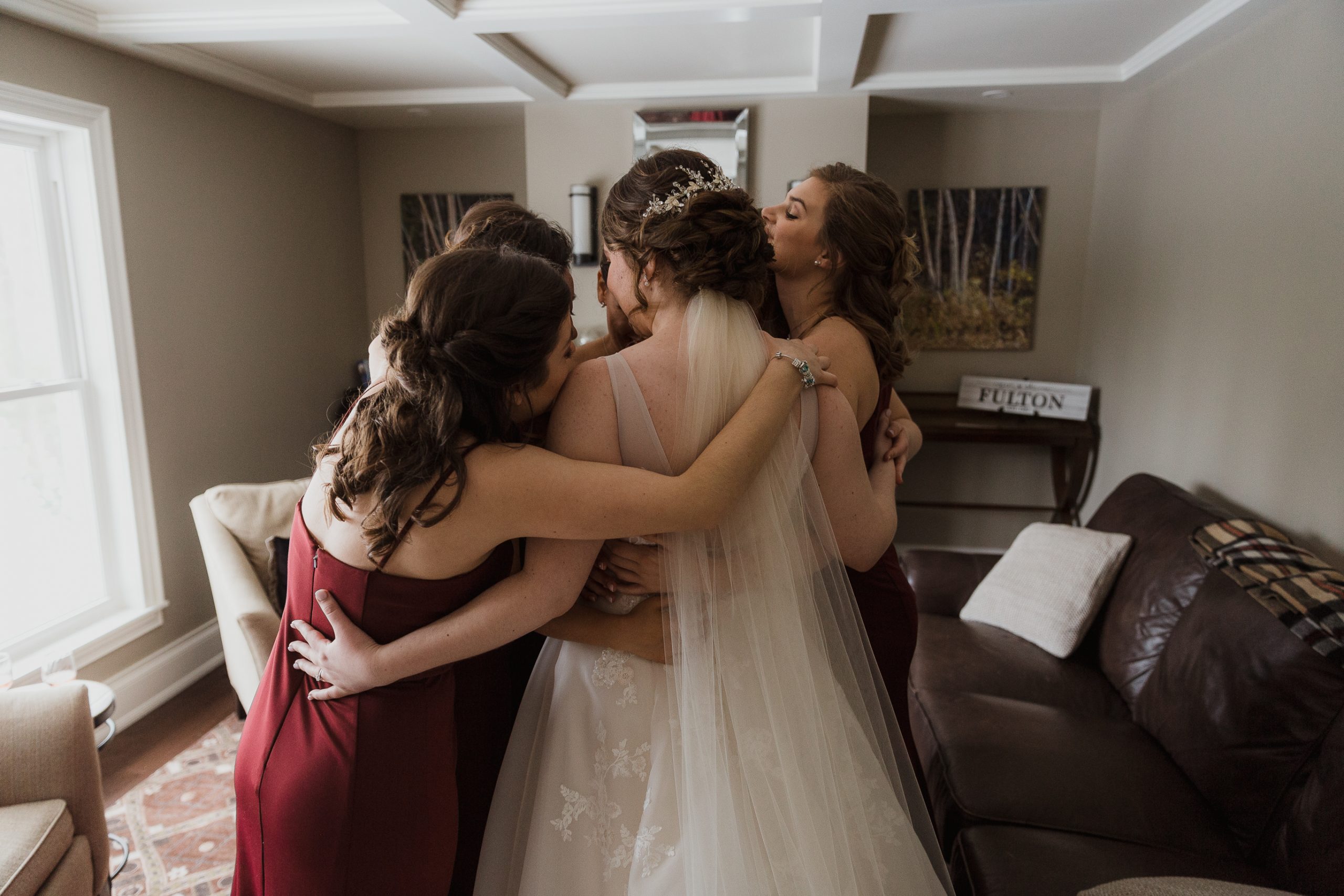 Wedding photos girls getting ready special moment between bride and bridesmaids, hugging