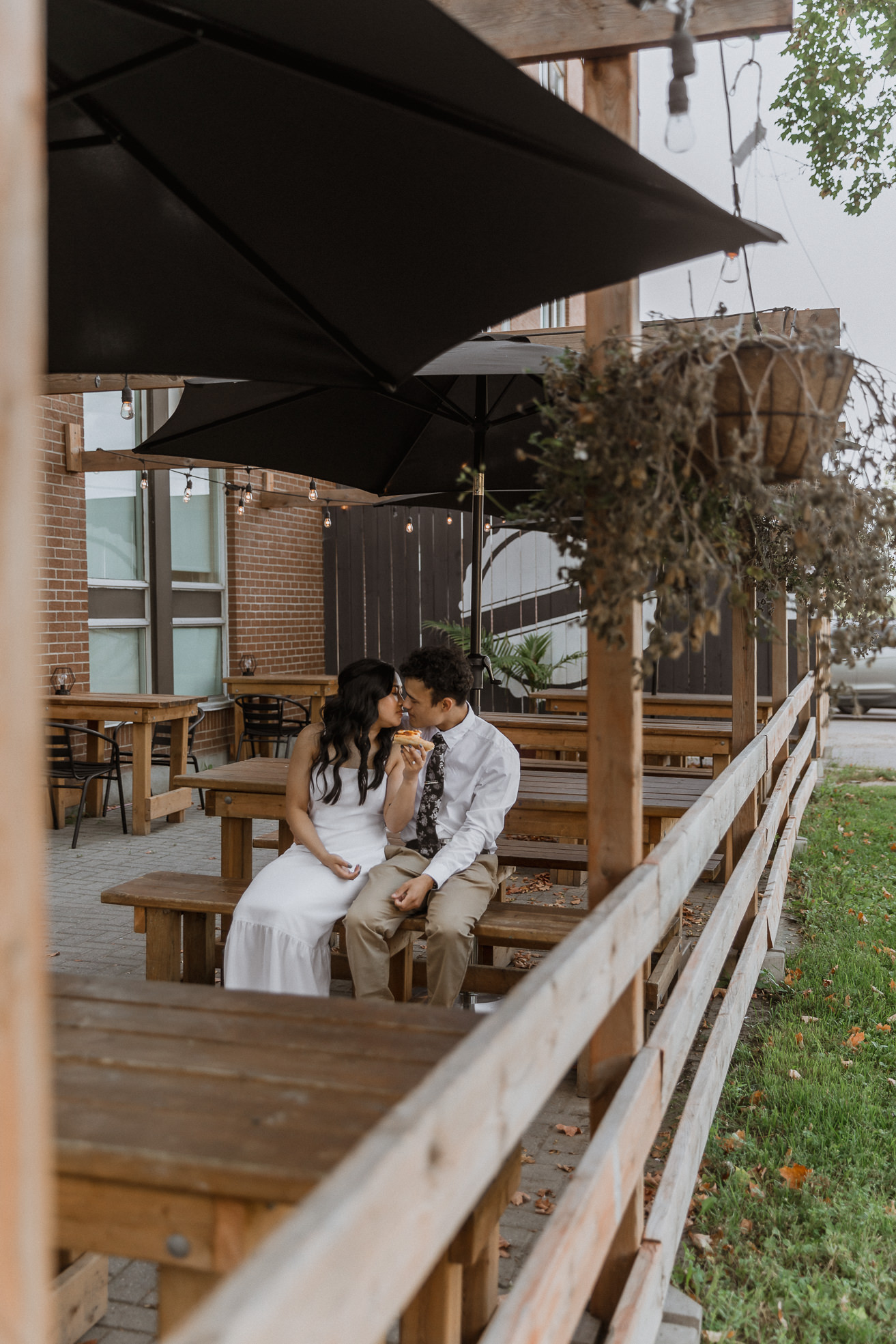 bride and groom eating pizza at patio - Sonia V Photo -Documentary Style Candid Photographer - Ottawa Ontario Kemptville Destination Photographer - Authentic Colour Photography - Wedding Photographer - Branding Photographer - Small Business Headshots - Engagement Photos - Family Portraits - Lifestyle
