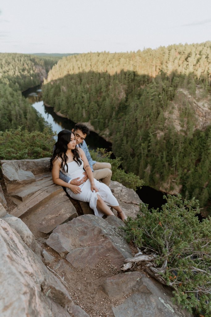 bride and groom sitting on the edge of a cliff at Barron Canyon in Algonquin Park after their elopement - Sonia V Photo -Documentary Style Candid Photographer - Ottawa Ontario Kemptville Destination Photographer - Authentic Colour Photography - Wedding Photographer - Branding Photographer - Small Business Headshots - Engagement Photos - Family Portraits - Lifestyle