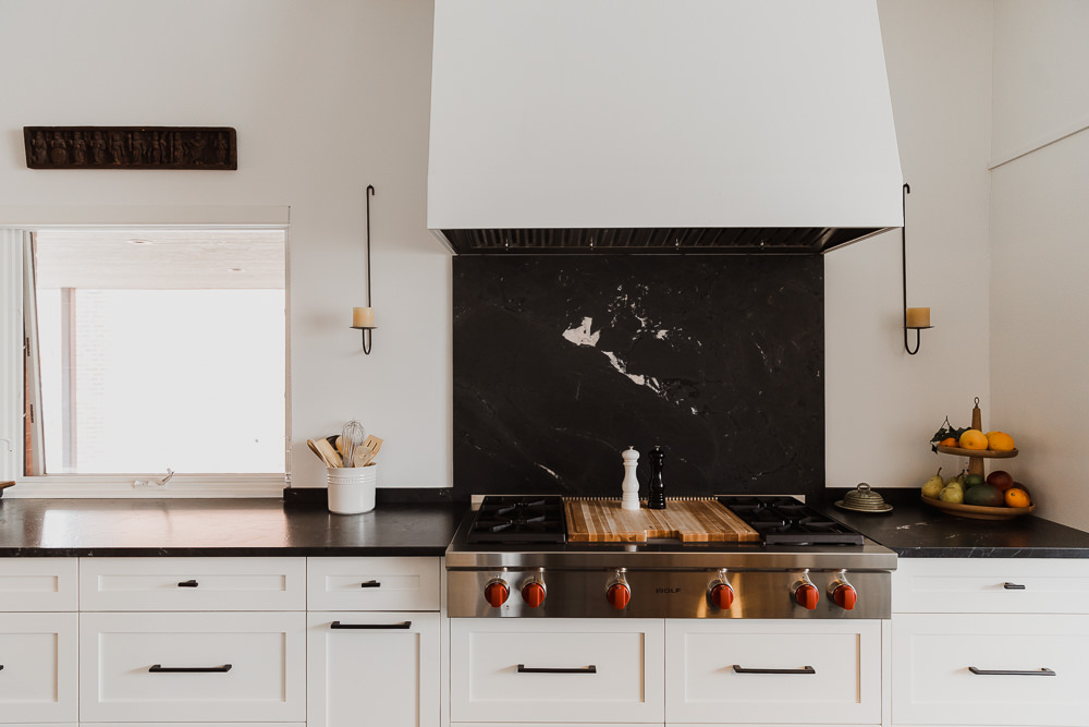 Black stone backsplash Kitchen with large island lamp and rattan stoolsIndian inspired home in the Glebe Ottawa Ontario Studio-Kahaani-Ottawa-interior-design-inspiration-ideas-brand-photos-by-Sonia-V-Photography