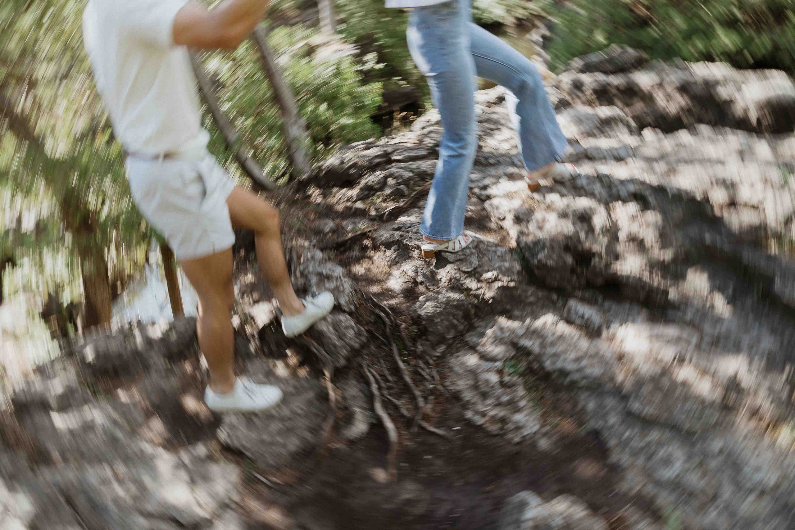 Engagement photos at Guelph conservation area, guelph lake, harris mill ruins, Sonia V Photography couple walking on rocks in front of lake trees water outfit closeup, creative, blurry artsy shot