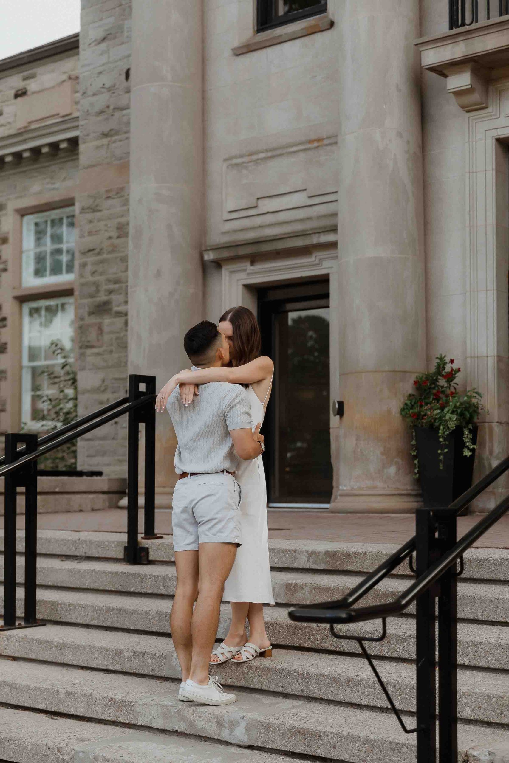 Engagement photos at Guelph University outside the old buildings | Sonia V Photography kissing on stairs