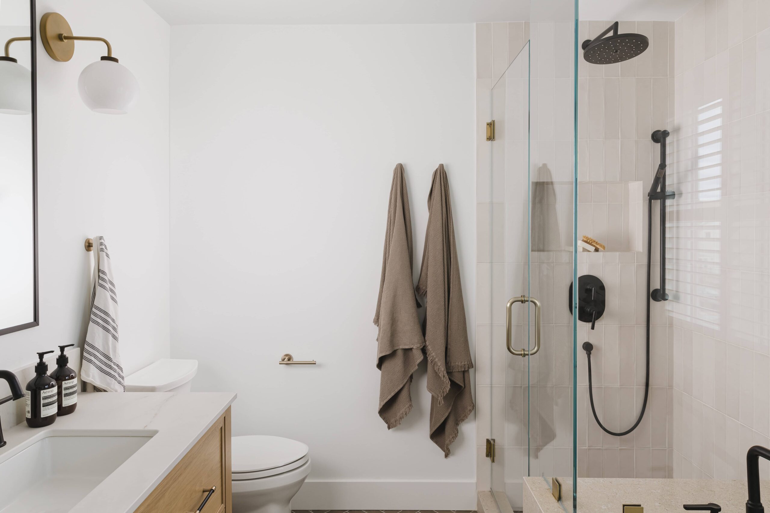 Warm Open-Concept Kitchen & Bath with Brass Accents - Sonia V Photography