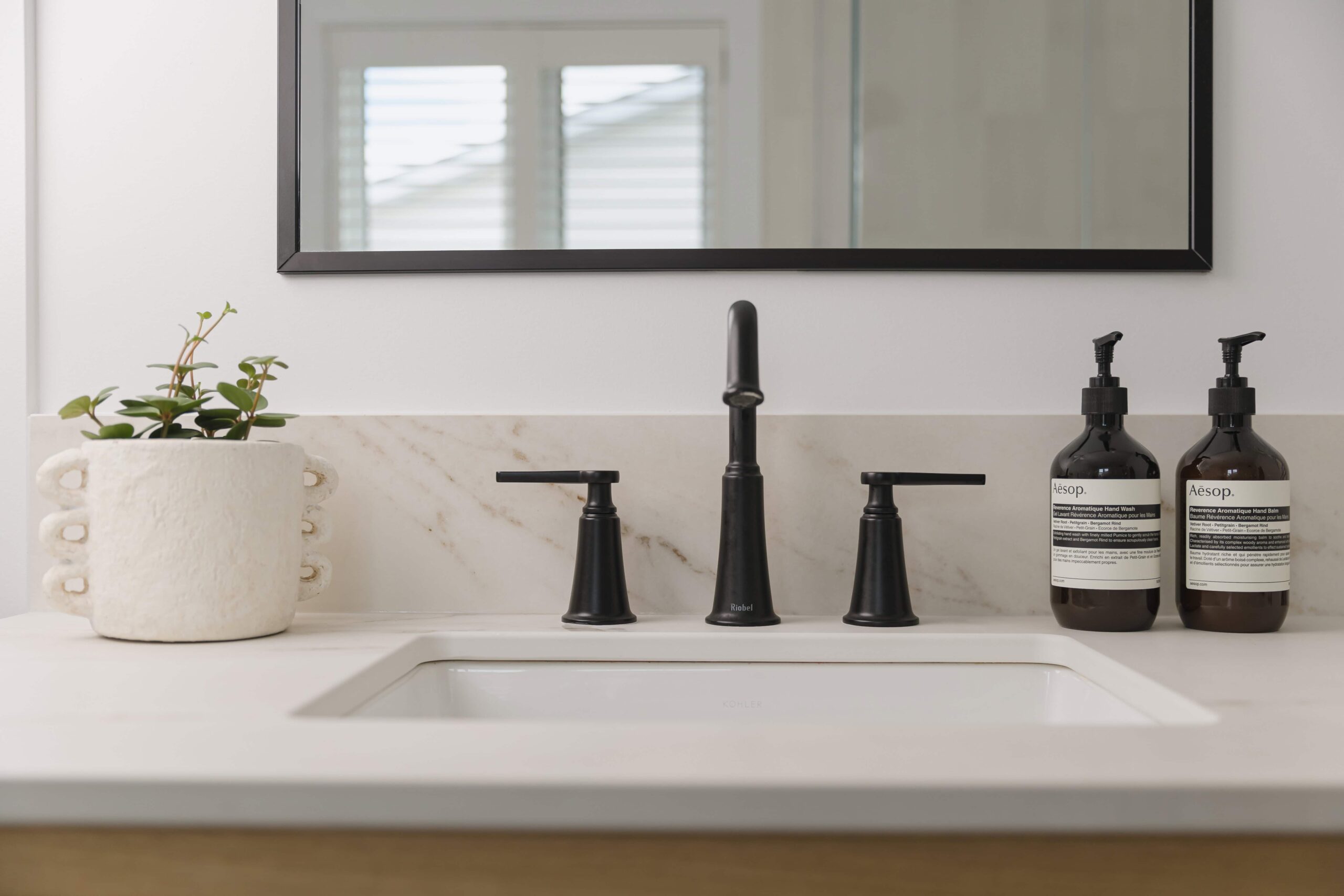 Warm Open-Concept Kitchen & Bath with Brass Accents - Sonia V Photography